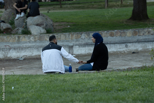 Arab couple on romantic picnic in a park in the city center
