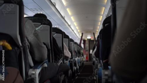 Video of flight in the plane. Unrecognisable passengers sitting in chairs on the plane. Footage can be used for your video.