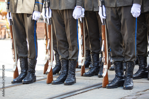 Closeup of soldiers legs and guns photo
