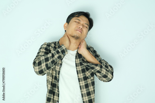 Young Asian man suffering pain of his neck photo