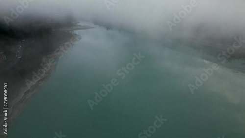 Lago de Barcis, Lago en Italia, entre las motañas de los alpes que pertenece a los dolomitas, drone video en Italia, nubes. photo