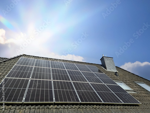Solar panels producing clean energy on a roof of a residential house © Michael