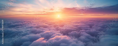 Beautiful sunset and cloudy sky from aerial view. Airplane view above clouds, panoramic banner background. © inthasone