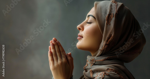 beautiful young muslim lady in scarf performing namaz prayer making dua photo