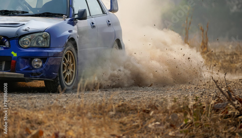 Rally racing car turning in curuve on dirt track. photo