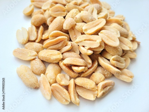 Bigger portion of peanuts on a bright background.