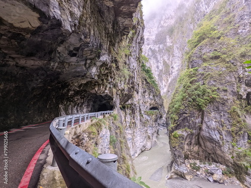 Taroko, Taiwan - 11.26.2022: Partly opened section of Swallow Grotto Trail with no people under marble cliffs along Liwu River in a gorge in the mist before the 403 earthquake during the pandemic photo