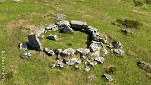 Grimspound prehistoric Late Bronze Age site. Dartmoor, England. From 1300 BC. Aerial video fly in low to stone hut circle photo