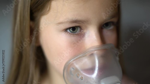 using a breathing mask at home. child with mask. photo