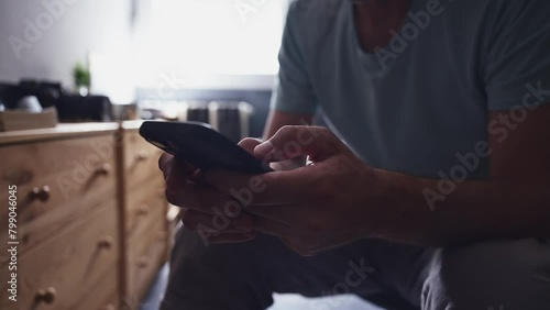 Close up of male hands using mobile phone indoors