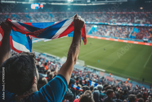 Fan holding flag in stadium during soccer game