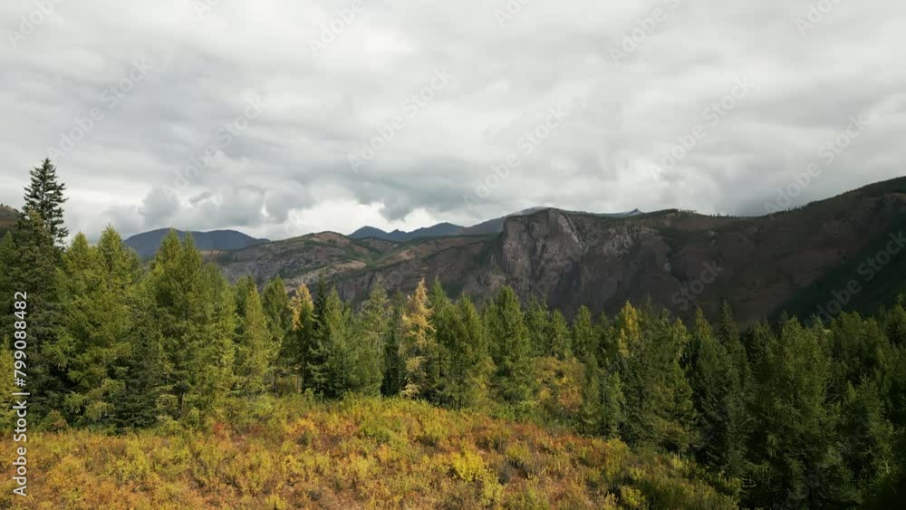 Aerial shot of Altay mountains. Mountains, peaks, cliffs, rocks, ridges, landscape, green grass, sky, clouds, nature, uncultivated nature, drone video. Aerial shot of Altay mountains. Mountains, peaks, cliffs, rocks, ridges, landscape, green grass, sky, clouds, nature, uncultivated nature, drone video.