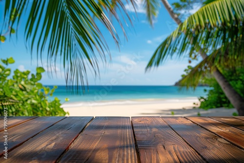 An empty wooden table with palm trees in the background