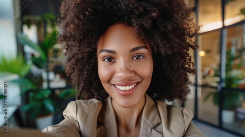 Businesswoman selfie and headshot with pleasant smile, new corporate job, and employee pleasure. Happy workplace, office, or online update on social media