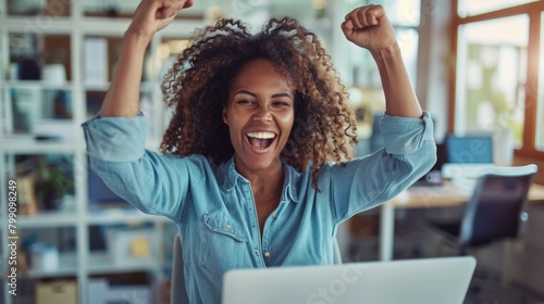 Young woman with laptop in fist celebrates good news. Surprised or female winner with digital device for happiness, smiling, and project success.