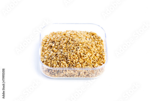 Dry food Daphnia for aquarium fish feed in a transparent box on White background.