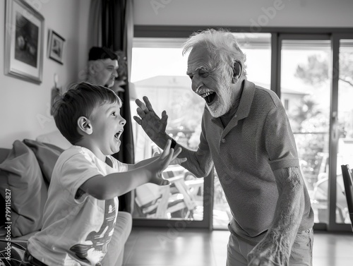 An Italian family, an elderly grandfather playing with his young grandson, joyfully shouting in the living room, black and white photograph