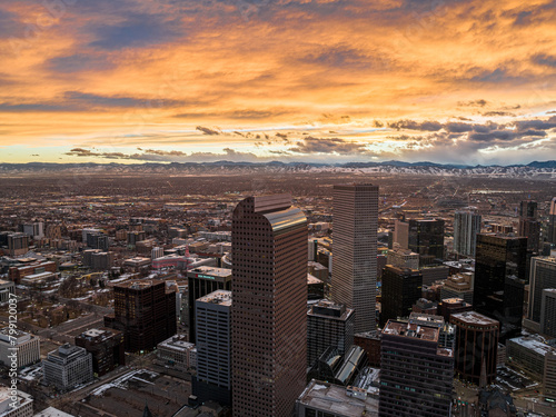 Aerial view of the Denver skyline glowing beneath a dramatic golden sunset