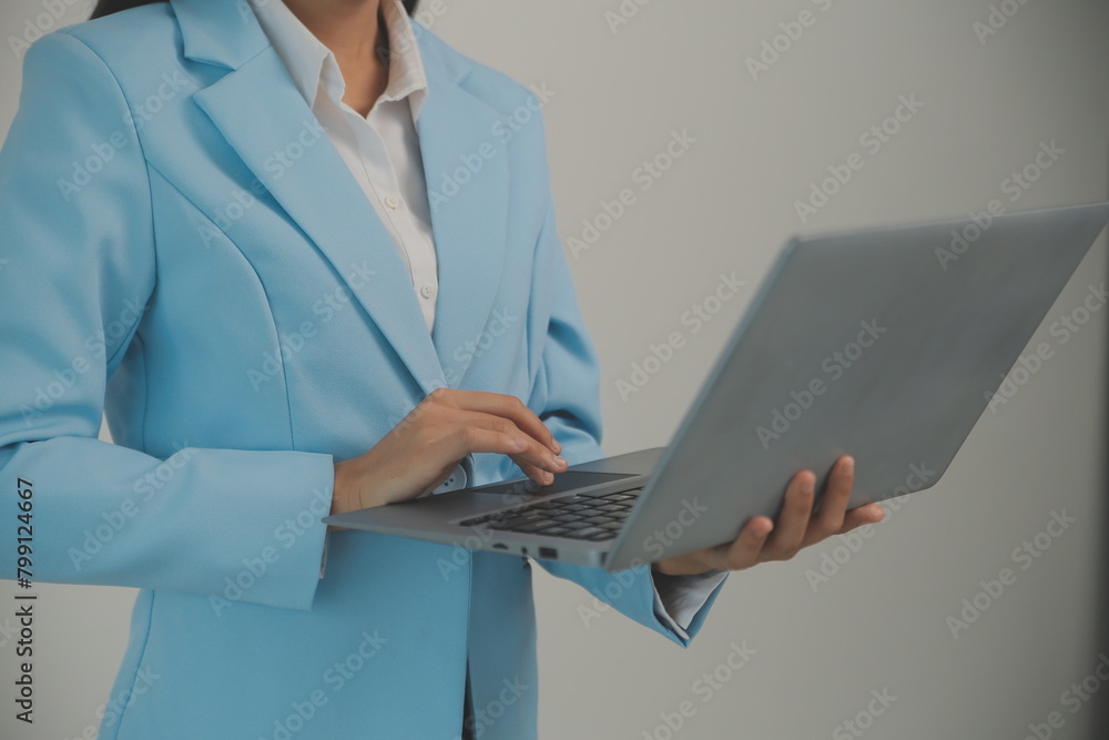 Portrait of a happy asian businesswoman working on laptop computer isolated over white background Portrait of a happy asian businesswoman working on laptop computer isolated over white background