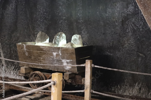 Old mine wagon with illuminated salt stones in Turda salt mine, Romania