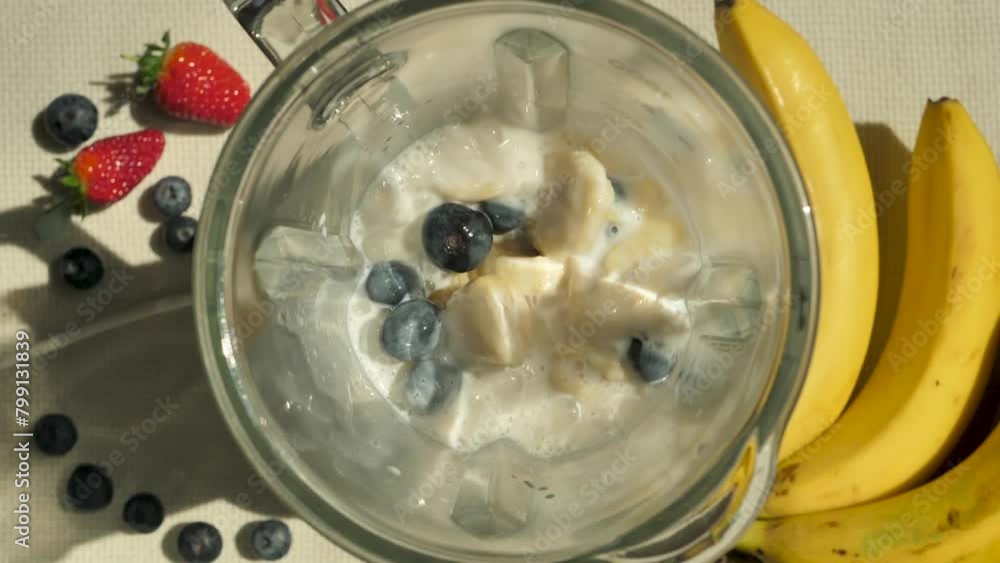 Grind the Top View berry milkshake in a blender and beat with the addition of blueberries and banana pieces. Prepare a berry-fruit smoothie using a blender. Slow motion cooking smoothie Grind the Top View berry milkshake in a blender and beat with the addition of blueberries and banana pieces. Prepare a berry-fruit smoothie using a blender. Slow motion cooking smoothie