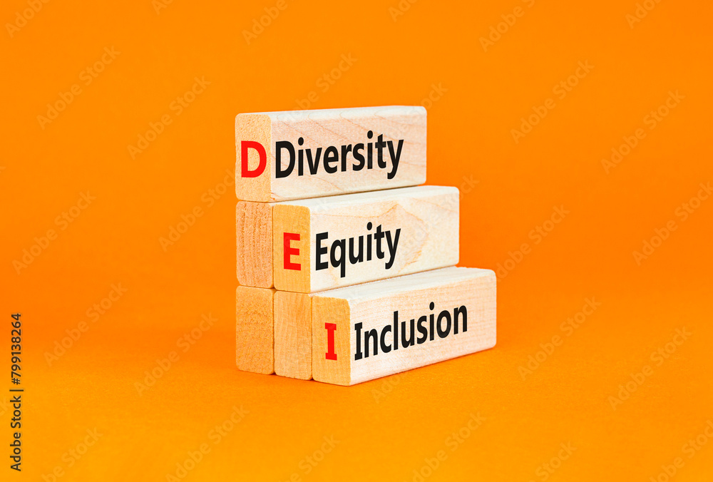 Naklejka premium DEI diversity equity and inclusion symbol. Concept words DEI diversity equity inclusion on blocks. Beautiful white background. Business DEI diversity equity and inclusion concept. Copy space.