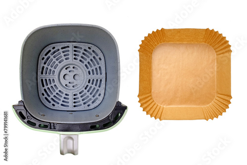 Top view of empty air fryer's basket and disposable greaseproof wax paper liner isolated on white background with clipping path. Healthy cooking concept without contaminating the fryer. photo