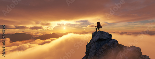 Adventure Woman Hiker Standing on a peak. Mountain Landscape in Background. Dramatic Sunset. © edb3_16
