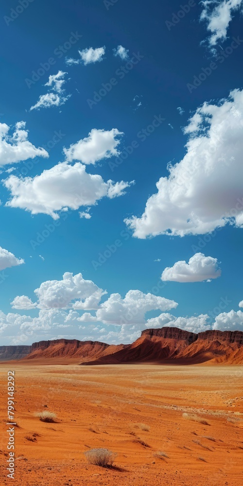 A vast desert landscape with red rocks and blue sky A vast desert landscape with red rocks and blue sky