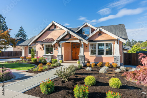 A newly constructed soft peach craftsman cottage style home, showcasing a triple pitched roof, thoughtful landscaping, a direct pathway photo