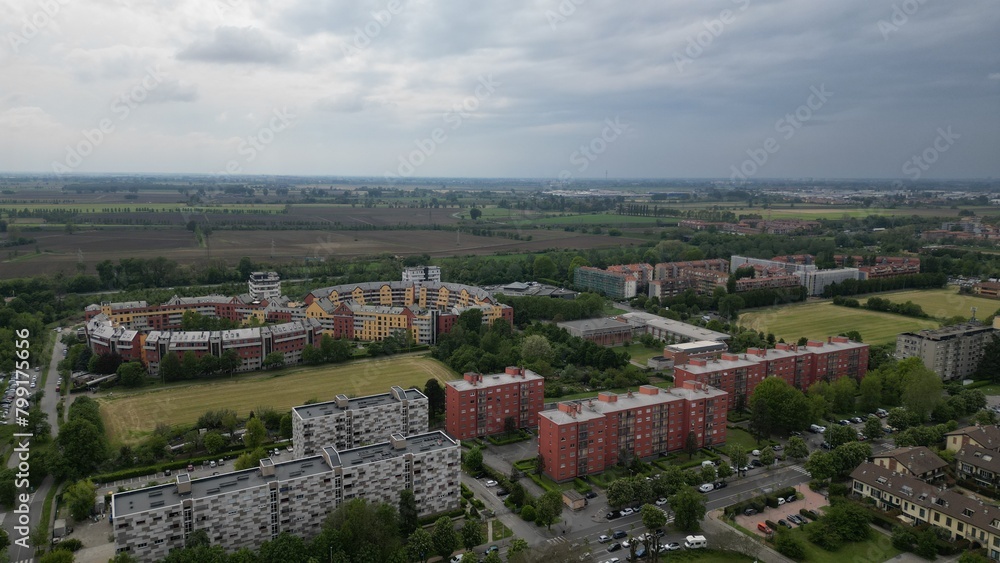 Apartments in residential complex. Housing structure at modern house, Europe. Rental home.Top view of the city San Giuliano Milanese. Drone view of houses and streets on a spring day. Milan, Italy