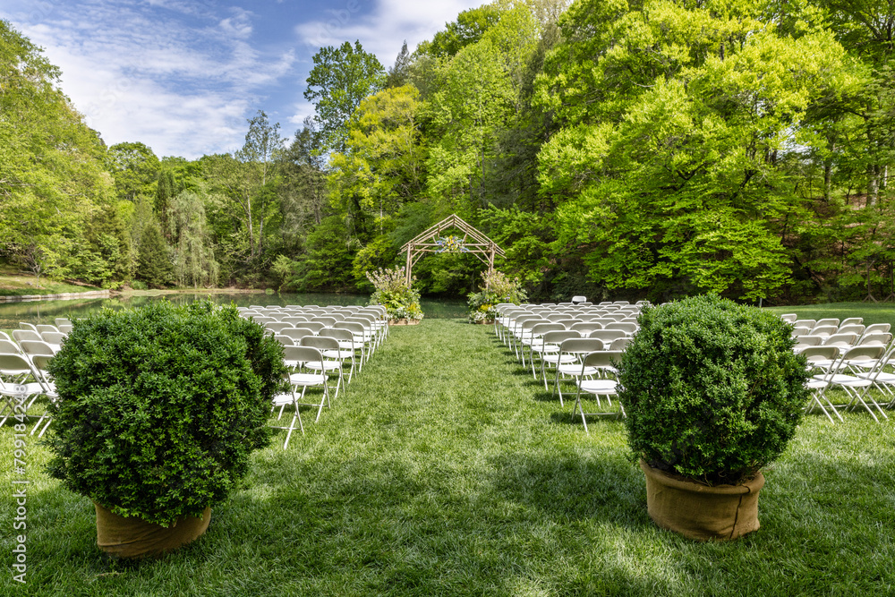 Chairs set up in a garden, waiting for the bride and groom