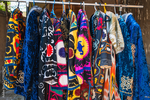 festive Uzbek dresses and female clothes with a colorful pattern at oriental bazaar in Uzbekistan in Tashkent