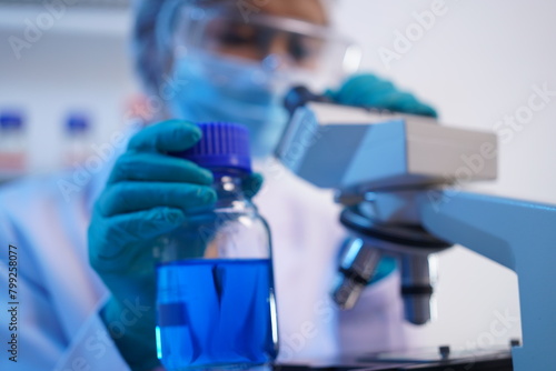 Science test tubes, laboratory equipment for new medical research, microbiology research with small pipettes in close-up. Asian and African female scientists in the laboratory, perfume samples