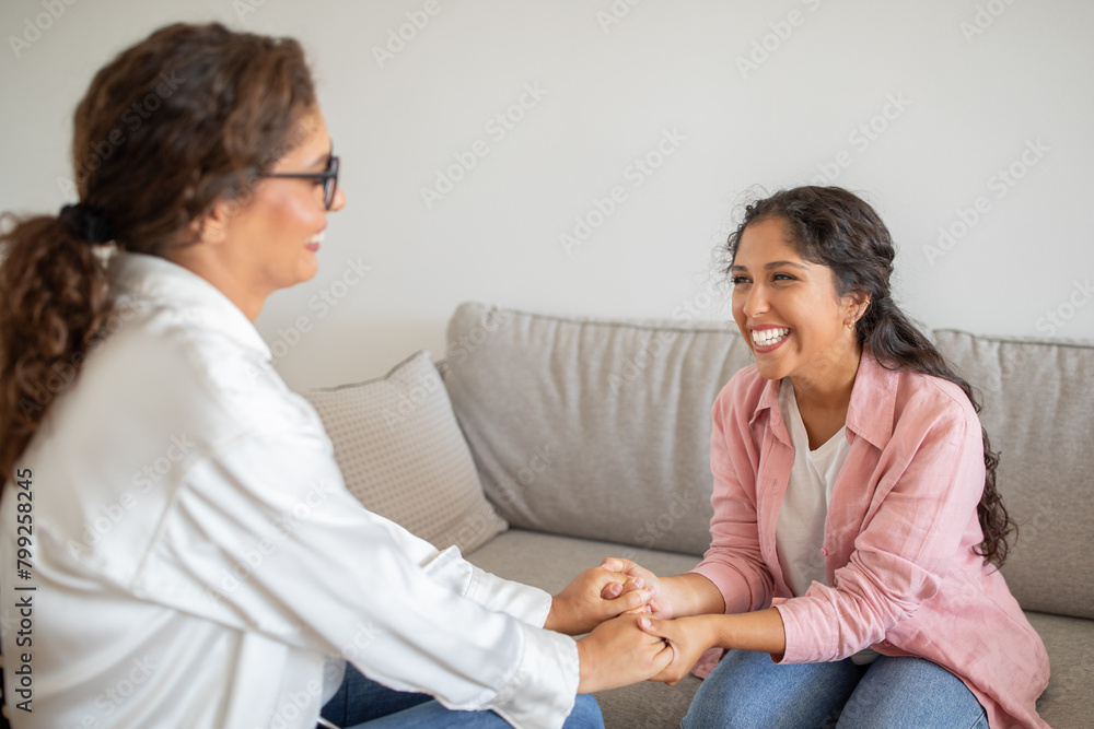 Happy young woman holding her therapist hands and smiling Happy young woman holding her therapist hands and smiling