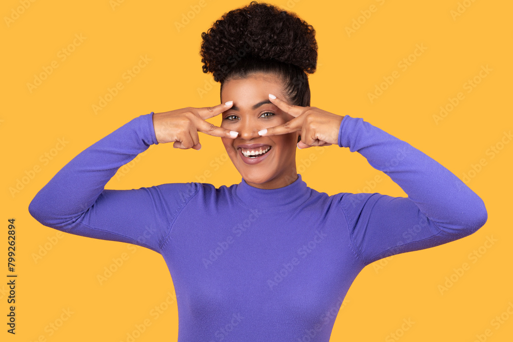 Woman Making Peace Gesture With Hands Next to Eyes Woman Making Peace Gesture With Hands Next to Eyes