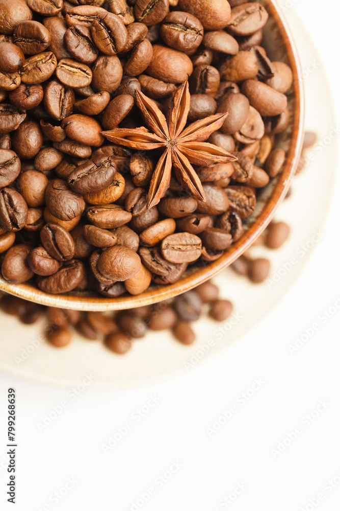 Fototapeta premium Cup with coffee beans and spices on white background. Top view. Space for a text