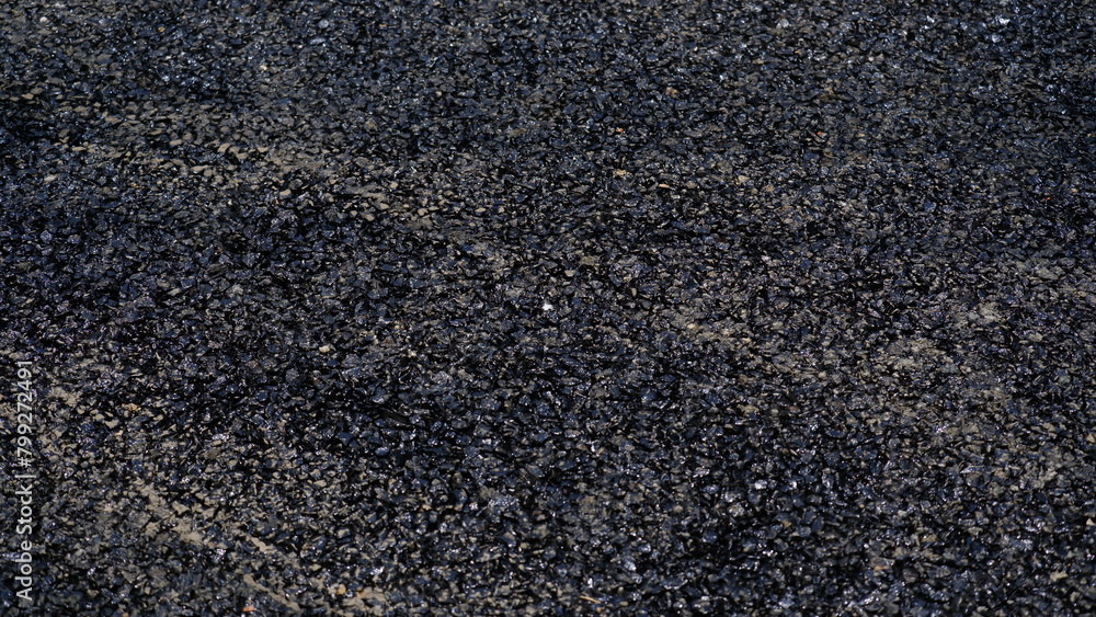 Stone chips melted on road due to high temperature in summer. Stone chips melted on road due to high temperature in summer.