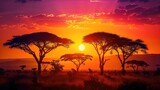 Sunset over the African savannah with wildlife and acacia trees.