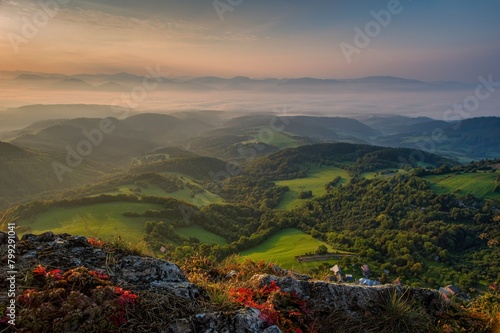 View colorful sunrise of the autumn landscape with forests and pastures with cattle. The White Carpathian Mountains, Slovakia, Europe. photo