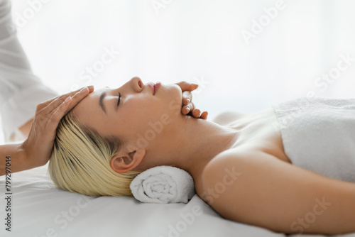 Woman Receiving Facial Massage From Woman Therapist