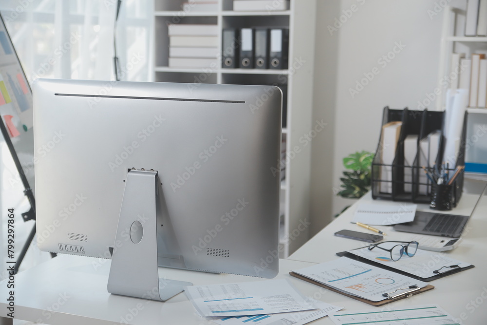 Laptop computer with opened lid on table in meeting room of office workspace. Laptop computer with opened lid on table in meeting room of office workspace.