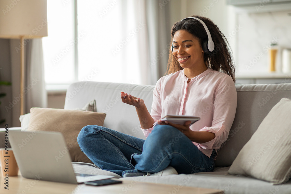 Young black woman attending webinar from home Young black woman attending webinar from home