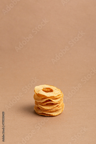 Healthy snack. Apple chips on a beige background.