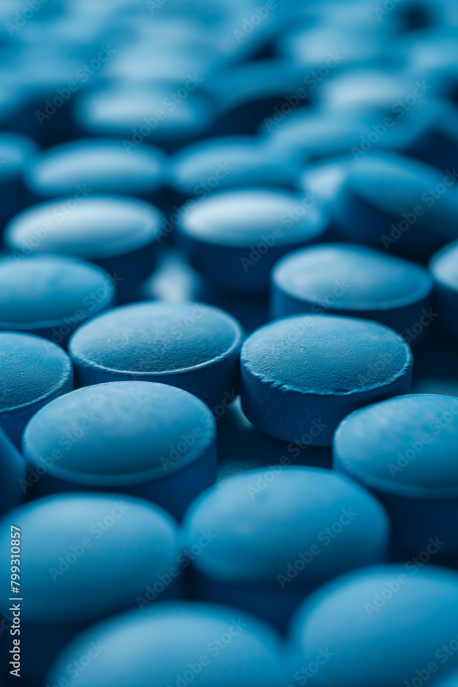 Pile of Blue Pills on Table Pile of Blue Pills on Table