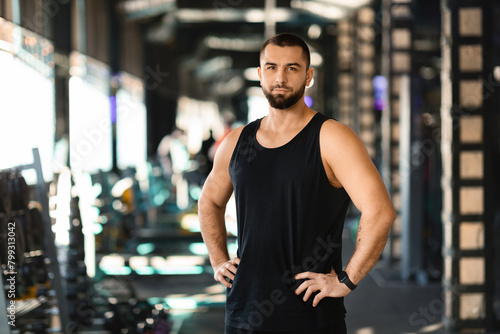 Man Standing in Gym With Hands on Hips