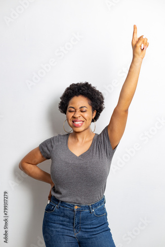 Happy and joyful African young woman emotionally holding her thumbs up.
