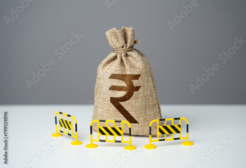 Indian rupee bag is fenced with barriers. Capital restrictions. Prevent rapid fluctuations in exchange rates. Limit investment opportunities. Limiting the amount of money flowing in or out. photo