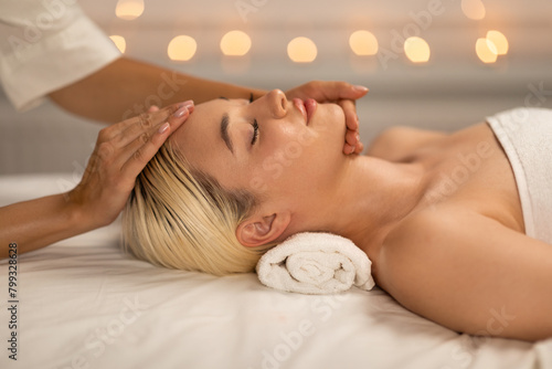 Pretty Blonde Woman Receiving Facial Massage at Spa
