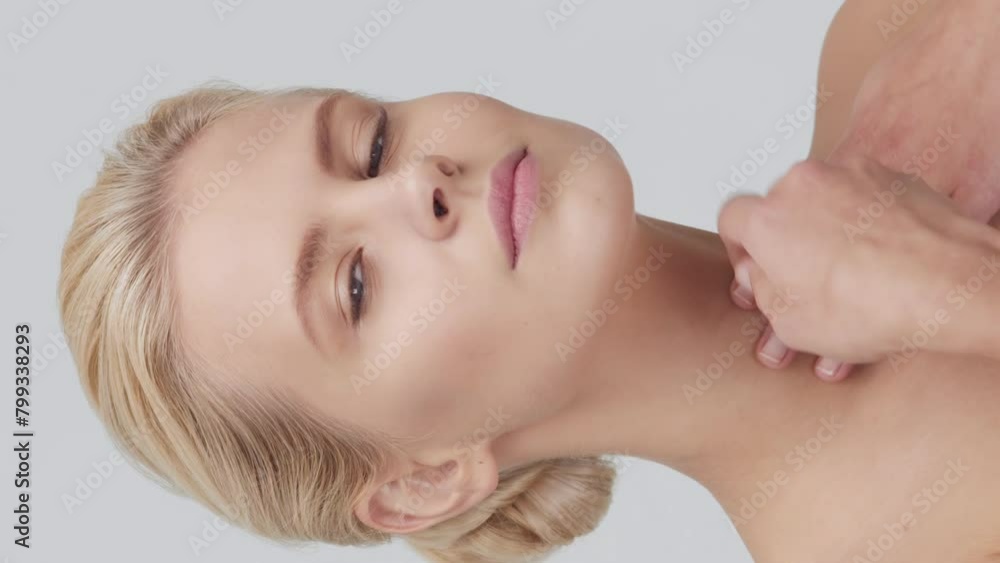 Studio portrait of young, beautiful and natural blond woman applying skin care cream. Vertical video. the concept of face lifting, cosmetics and make-up. Studio portrait of young, beautiful and natural blond woman applying skin care cream. Vertical video. the concept of face lifting, cosmetics and make-up.